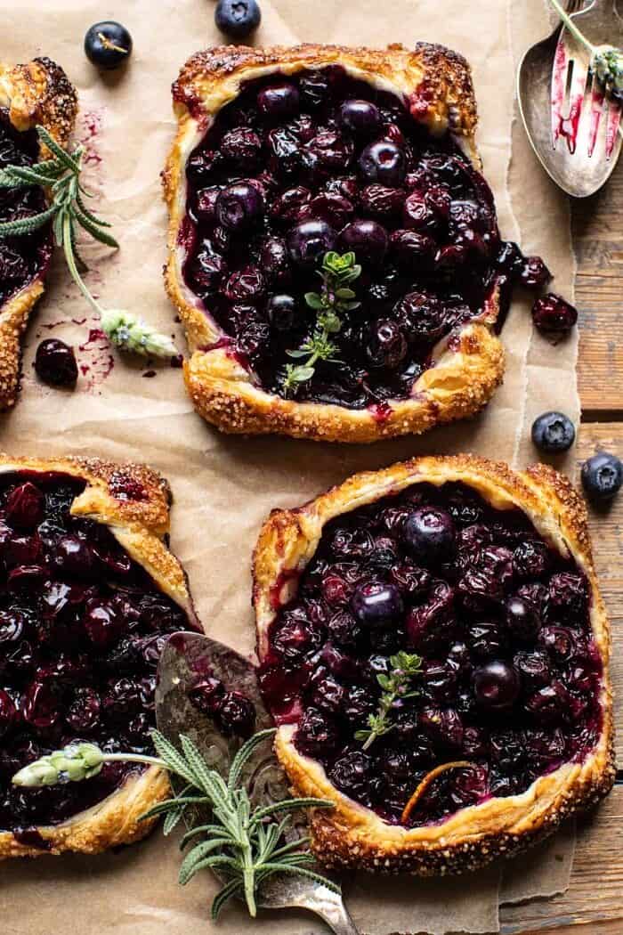 Bursting Blueberry Lemon Thyme Tarts | halfbakedharvest.com overhead photo of Bursting Blueberry Lemon Thyme Tarts