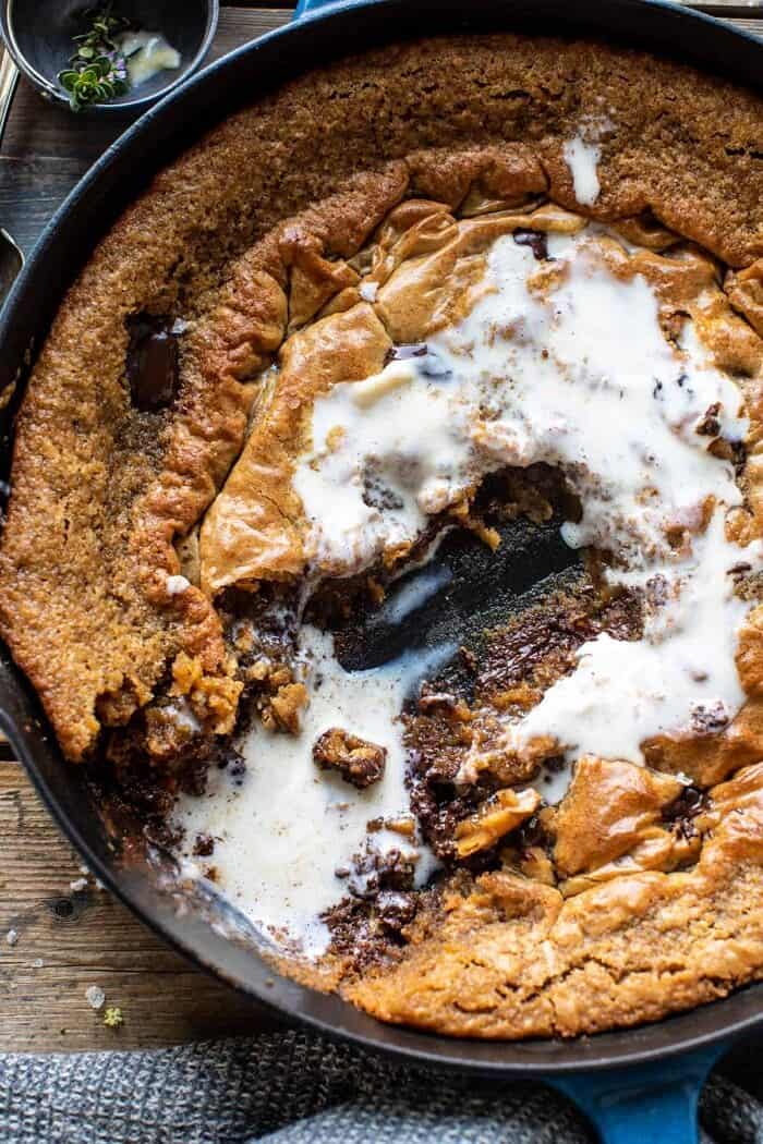 overhead close up photo of Crinkle Top Chocolate Peanut Butter Skillet Blondies with half of the blondie eaten