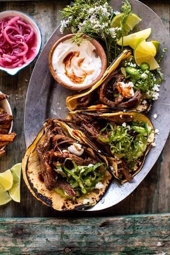 Crockpot Carne Asada Tacos with Cilantro Lime Garlic Sauce | halfbakedharvest.com