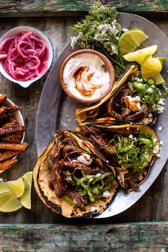 overhead photo of Crockpot Carne Asada Tacos with Cilantro Lime Garlic Sauce