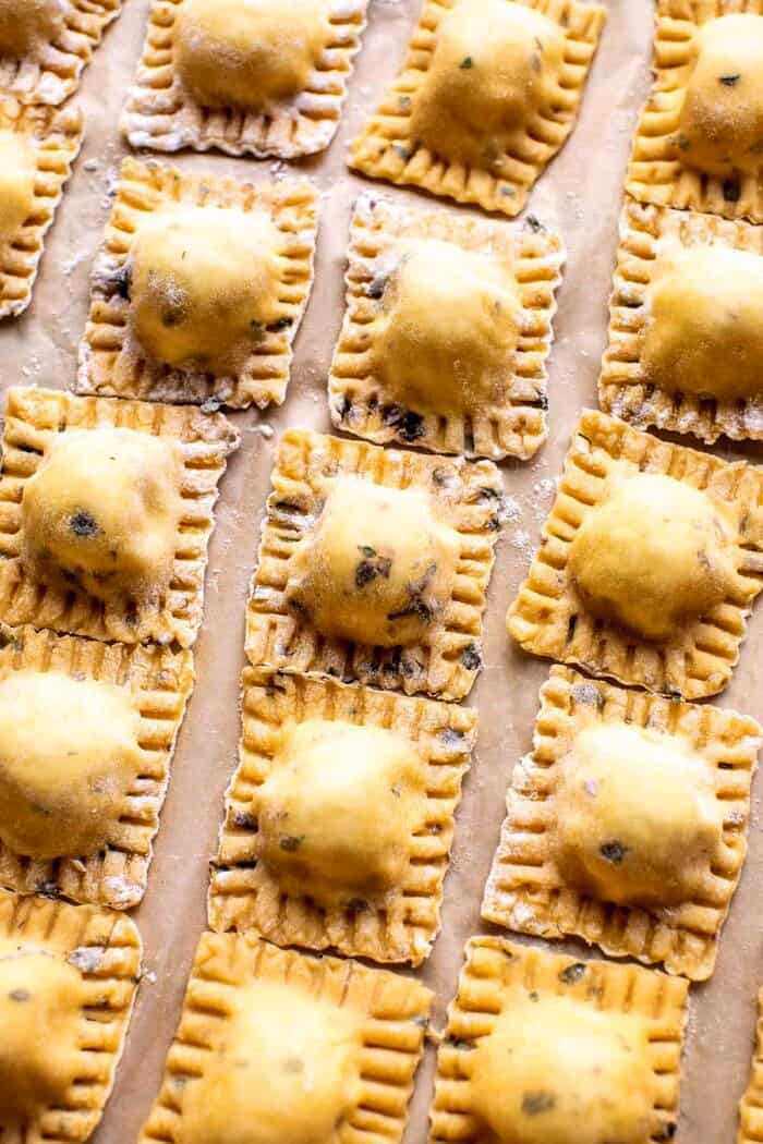 Lemon Butter Cheese Ravioli with Garlic Basil Breadcrumbs | halfbakedharvest.com prep photo of raw Cheese Ravioli on parchment paper before cooking