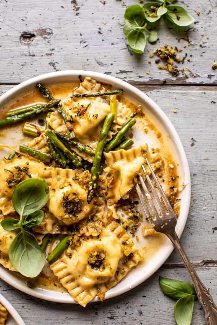 Lemon Butter Cheese Ravioli with Garlic Basil Breadcrumbs | halfbakedharvest.com overhead photo of Lemon Butter Cheese Ravioli with Garlic Basil Breadcrumbs and fork pushed into ravioli