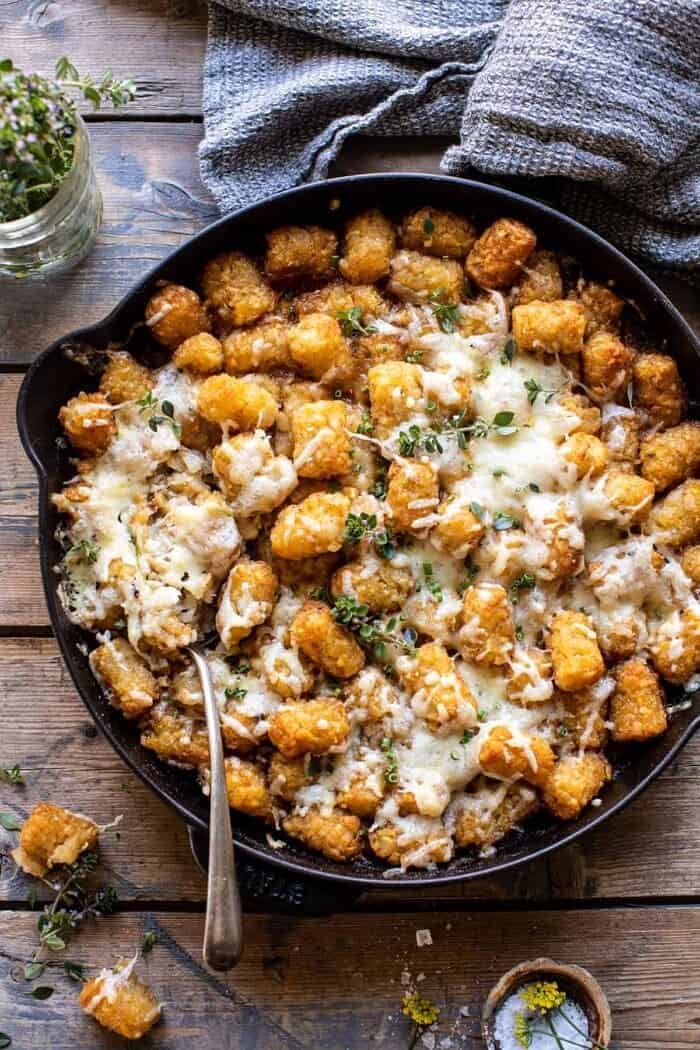 One Skillet French Onion Tater Tot Casserole | halfbakedharvest.com overhead photo of One Skillet French Onion Tater Tot Casserole with spoon in skillet