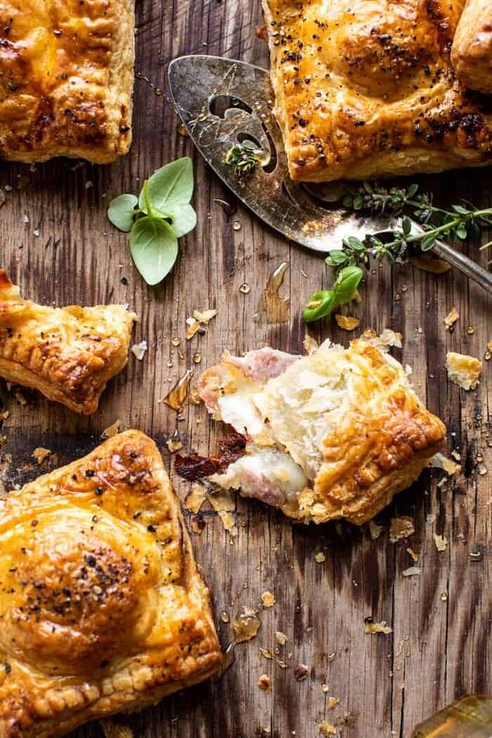 Prosciutto Caprese Puff Pastries with Peppery Thyme Honey | halfbakedharvest.com overhead photo of Prosciutto Caprese Puff Pastry torn in half to expose the filling inside