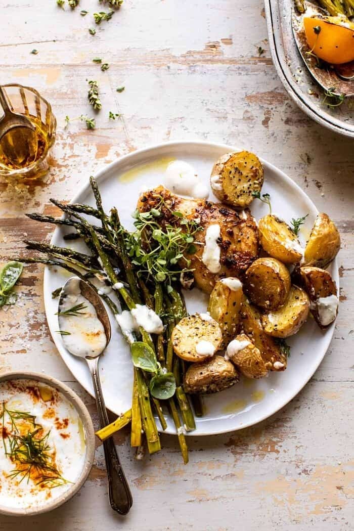 overhead photo of Sheet Pan Lemon Rosemary Dijon Chicken and Potatoes with Feta Goddess Sauce on serving plate