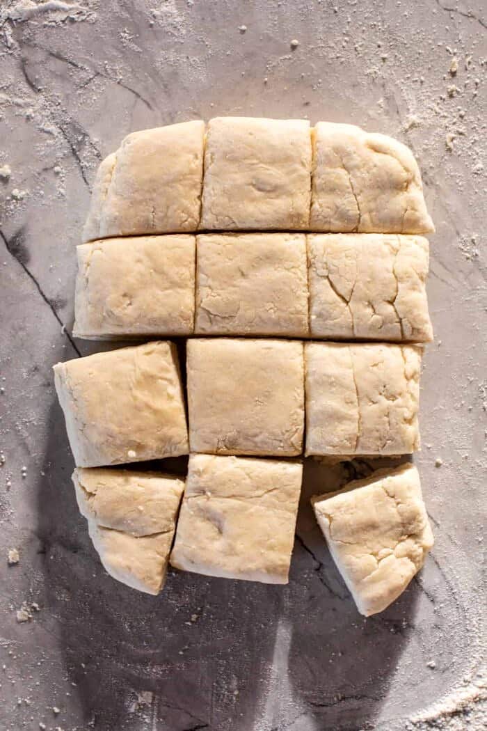 overhead prep photo of Layered Cream Cheese Biscuit dough cut into 12 biscuits before baking