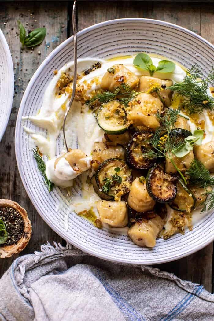 Cauliflower Gnocchi with Crispy Zucchini and Whipped Goat Cheese | halfbakedharvest.com photo of Cauliflower Gnocchi with Crispy Zucchini and Whipped Goat Cheese with fork in bowl