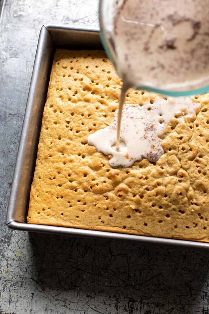 Dirty Horchata Tres Leches Cake | halfbakedharvest.com prep photo of pouring the milk over the Cake