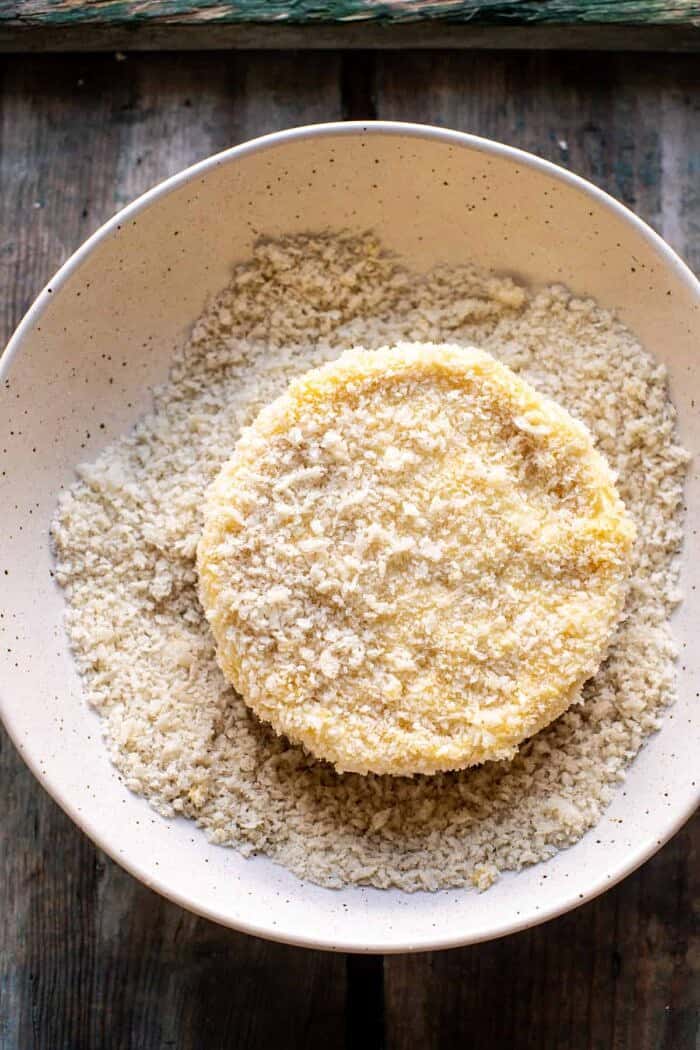 Pan Fried Brie with Peppered Honey and Olives | halfbakedharvest.com overhead prep photo of brie before cooking