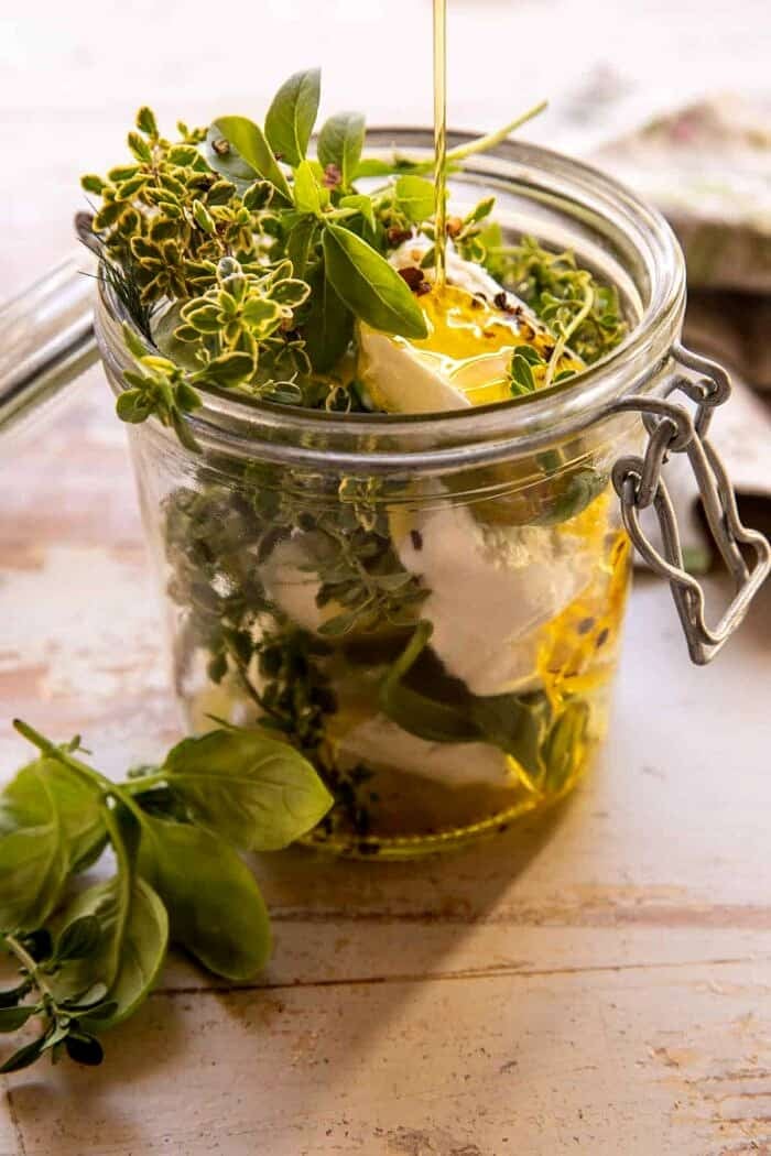 Marinated Goat Cheese Strawberry Crostini | halfbakedharvest.com side angle prep photo of Marinated Goat Cheese