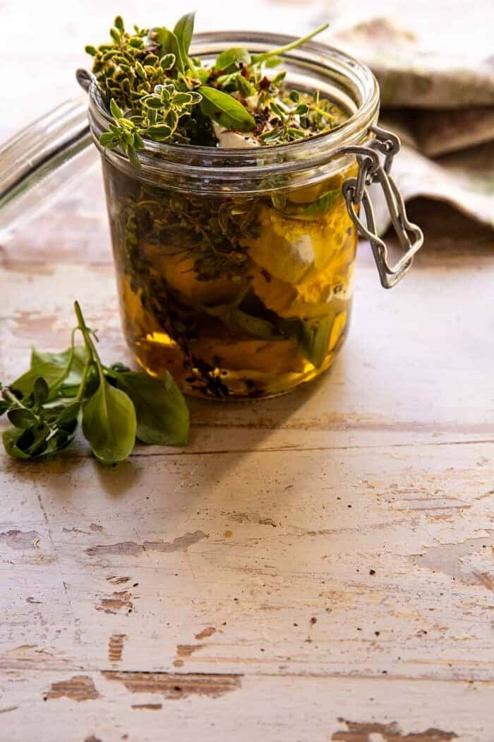 Marinated Goat Cheese Strawberry Crostini | halfbakedharvest.com side angled photo of Marinated Goat Cheese