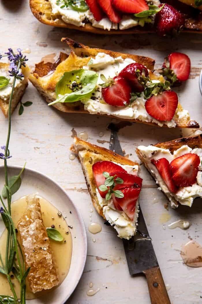 Marinated Goat Cheese Strawberry Crostini | halfbakedharvest.com overhead photo of Marinated Goat Cheese Strawberry Crostini cut in half