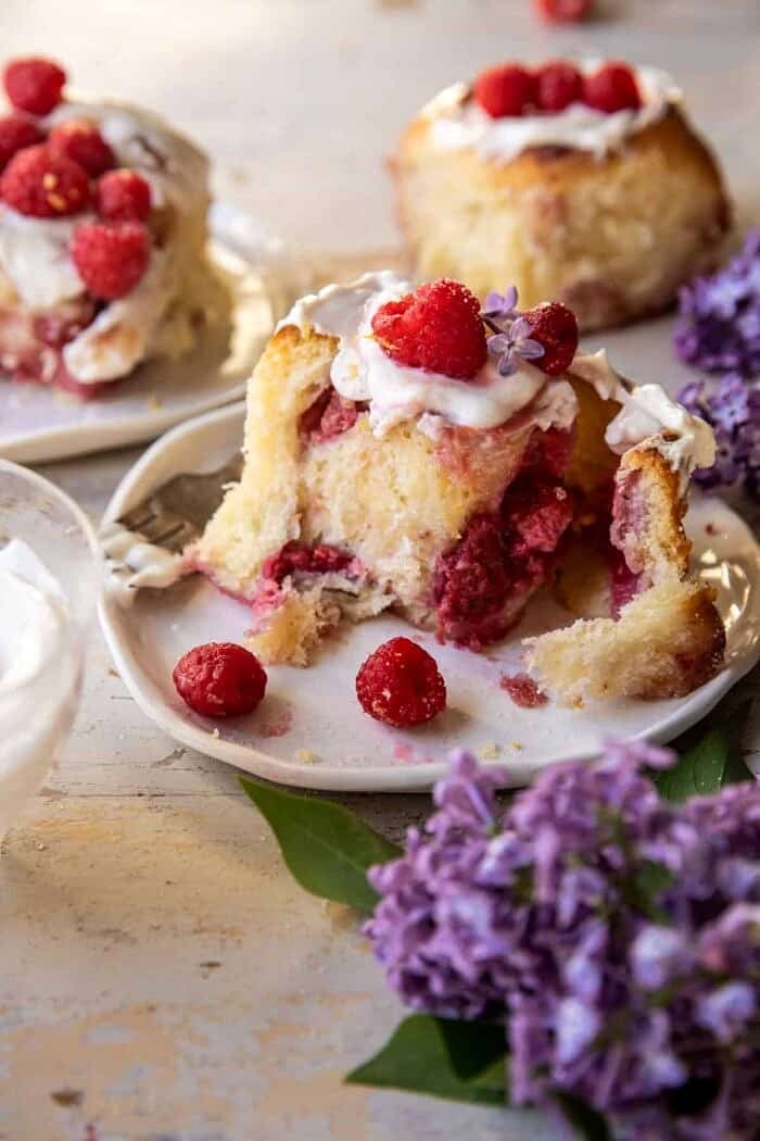 side angle close up photo of Raspberry Lemon Brioche Roll on plate with Whipped Ricotta Cream
