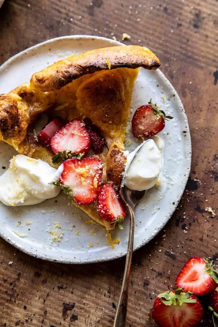 Lemon Strawberry Dutch Baby with Ricotta Cream | halfbakedharvest.com overhead photo of Lemon Strawberry Dutch Baby with Ricotta Cream on serving plate