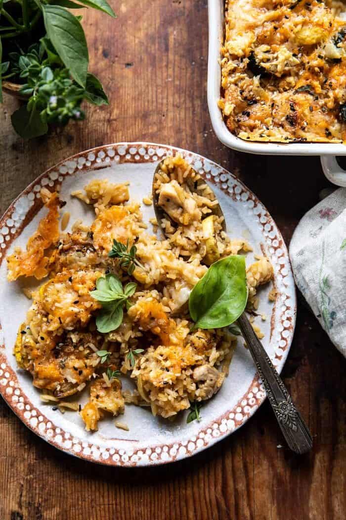 overhead photo of Cheesy Zucchini Chicken and Rice Bake on plate with spoon
