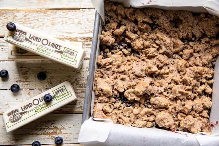 Cinnamon Sugar Blueberry Crumb Bars | halfbakedbarvest.com overhead prep photo of Cinnamon Sugar Blueberry Crumb Bars before baking