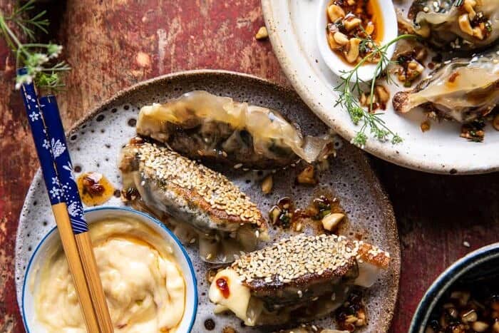 Crispy Sesame Ginger Potstickers with Chive Chili Sauce | halfbakedharvest.com overhead horizontal photo of Crispy Sesame Ginger Potstickers with Chive Chili Sauce