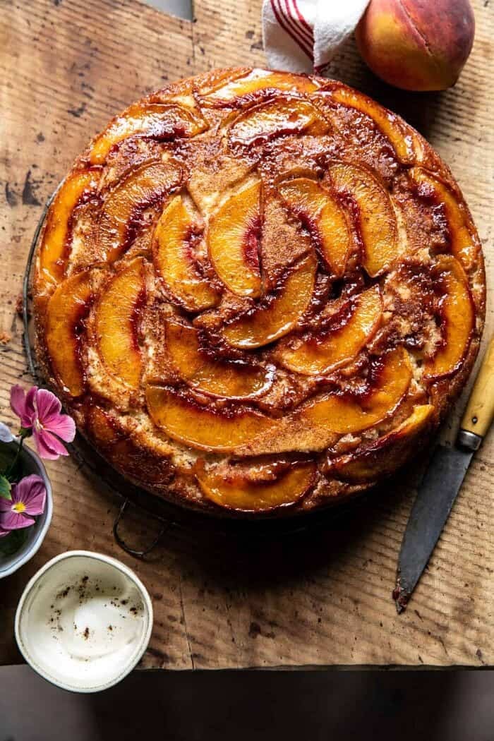 Skillet Cinnamon Sugar Peach Upside Down Cake | halfbakedharvest.com overhead photo of Skillet Cinnamon Sugar Peach Upside Down Cake before cutting