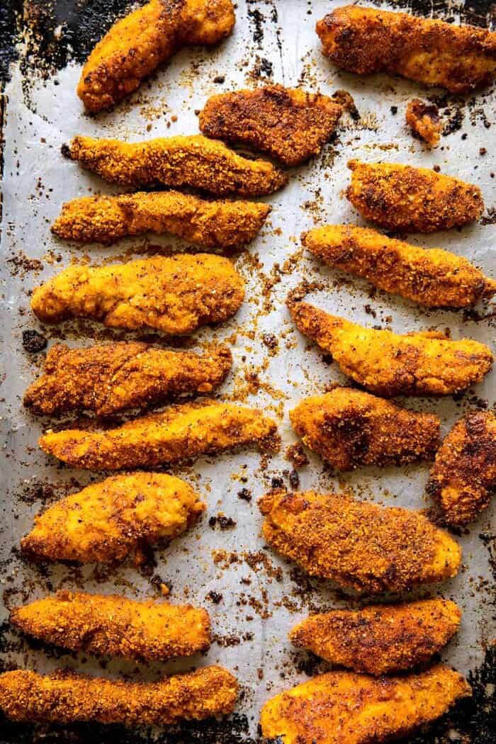 Black Pepper Rub Chicken Fingers with Greek Yogurt Ranch | halfbakedharvest.com Black Pepper Rub Chicken Fingers on baking sheet after baking