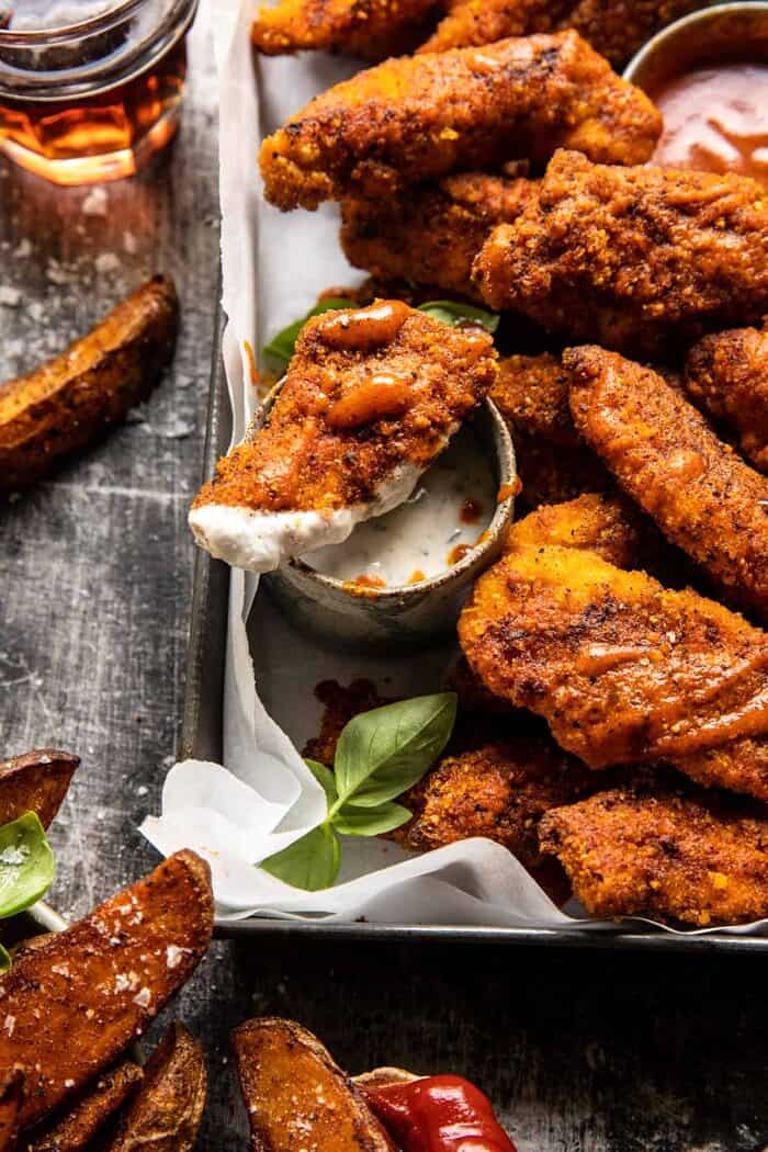 Black Pepper Rub Chicken Fingers with Greek Yogurt Ranch | halfbakedharvest.com side angled close up photo of Black Pepper Rub Chicken Fingers with Greek Yogurt Ranch