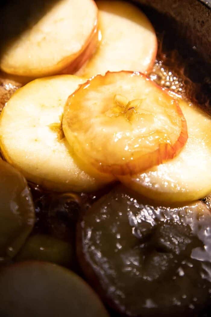 Salted Maple Apple Tarte Tatin with Cinnamon Pumpkin Seeds | halfbakedharvest.com prep photo of apples cooking in maple