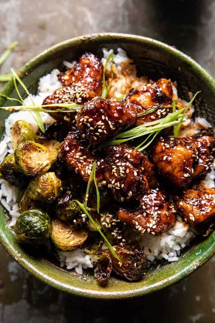 Sheet Pan Sticky Ginger Sesame Chicken and Crispy Brussels Sprouts | halfbakedharvest.com overhead close up photo of Sheet Pan Sticky Ginger Sesame Chicken and Crispy Brussels Sprouts