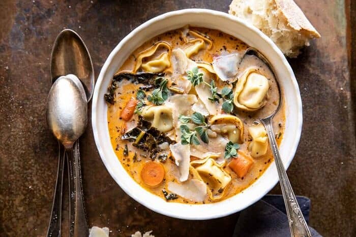overhead horizontal photo of Healthier Slow Cooker Creamy Tortellini Vegetable Soup