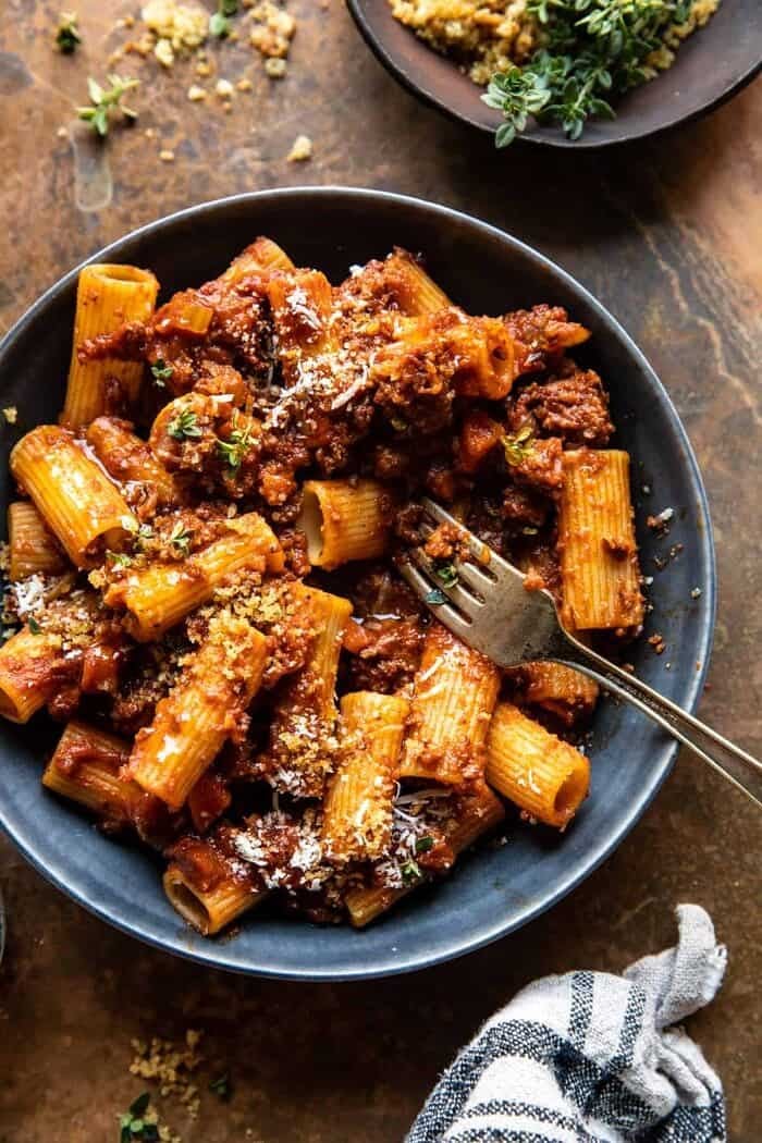 Slow Cooker Saucy Sunday Bolognese Pasta | halfbakedharvest.com overhead photo of Slow Cooker Saucy Sunday Bolognese Pasta with fork in bowl