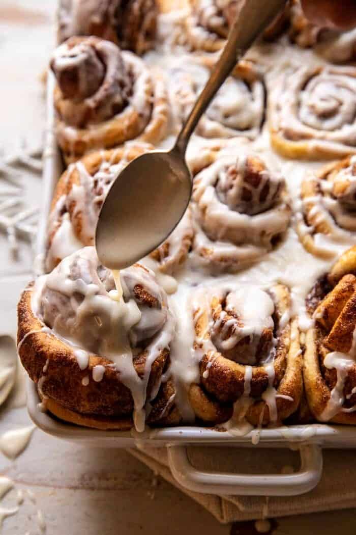 Easy Fluffy Eggnog Cinnamon Rolls | halfbakedharvest.com side angled photo of Easy Fluffy Eggnog Cinnamon Rolls