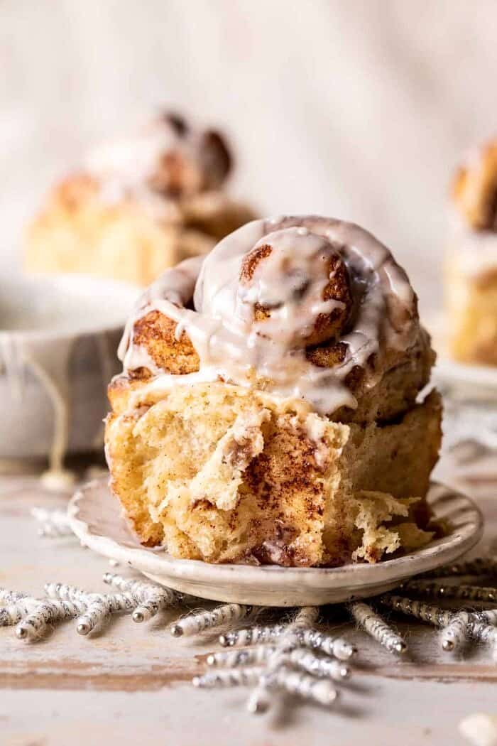 Easy Fluffy Eggnog Cinnamon Rolls | halfbakedharvest.com Easy Fluffy Eggnog Cinnamon Roll on plate