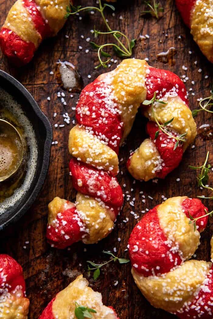 overhead close up photo of Salted Garlic Butter Candy Cane Bagels 