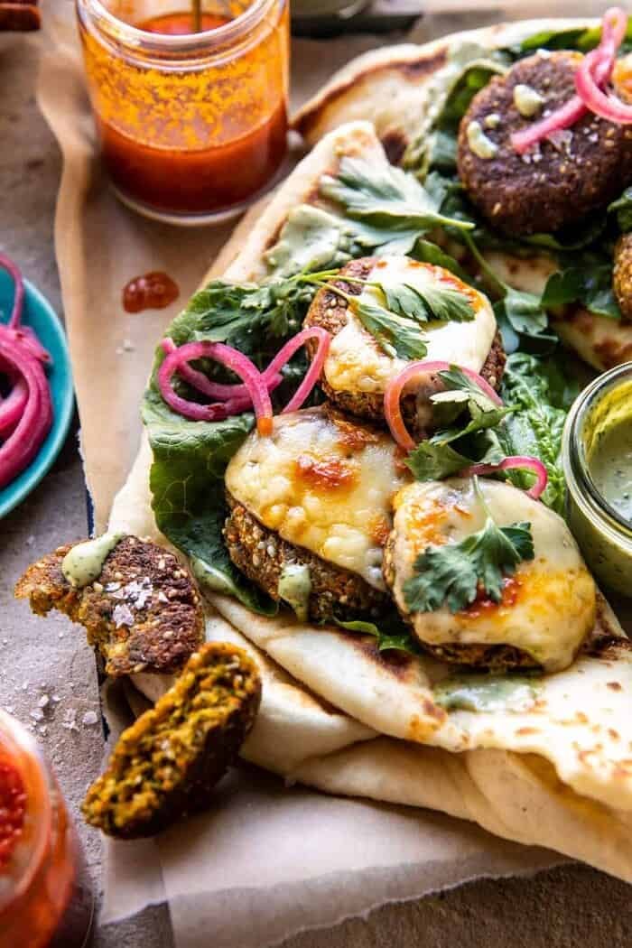 Crispy Sesame Falafel Melts with Garlicky Green Tahini | halfbakedharvest.com side angled photo of Crispy Sesame Falafel Melts with Garlicky Green Tahini