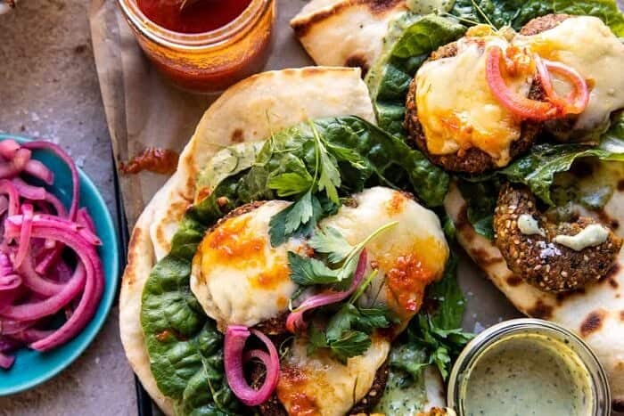 Crispy Sesame Falafel Melts with Garlicky Green Tahini | halfbakedharvest.com overhead horizontal photo of Crispy Sesame Falafel Melts with Garlicky Green Tahini