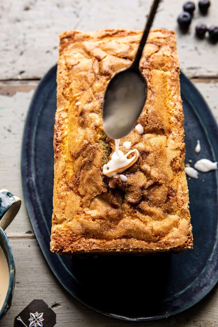 Earl Grey Blueberry Lemon Cake | halfbakedharvest.com glaze being drizzled on cake