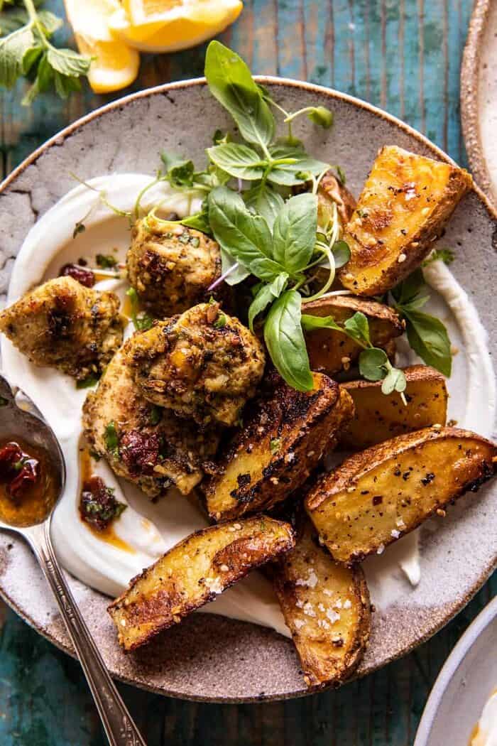 overhead close up photo of Sheet Pan Pesto Chicken and Lemon Butter Potatoes with Whipped Feta