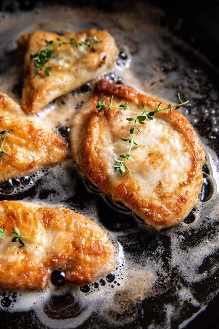 One Skillet Creamy Artichoke Chicken Marsala and Orzo | halfbakedharvest.com prep photo of chicken cooking in skillet