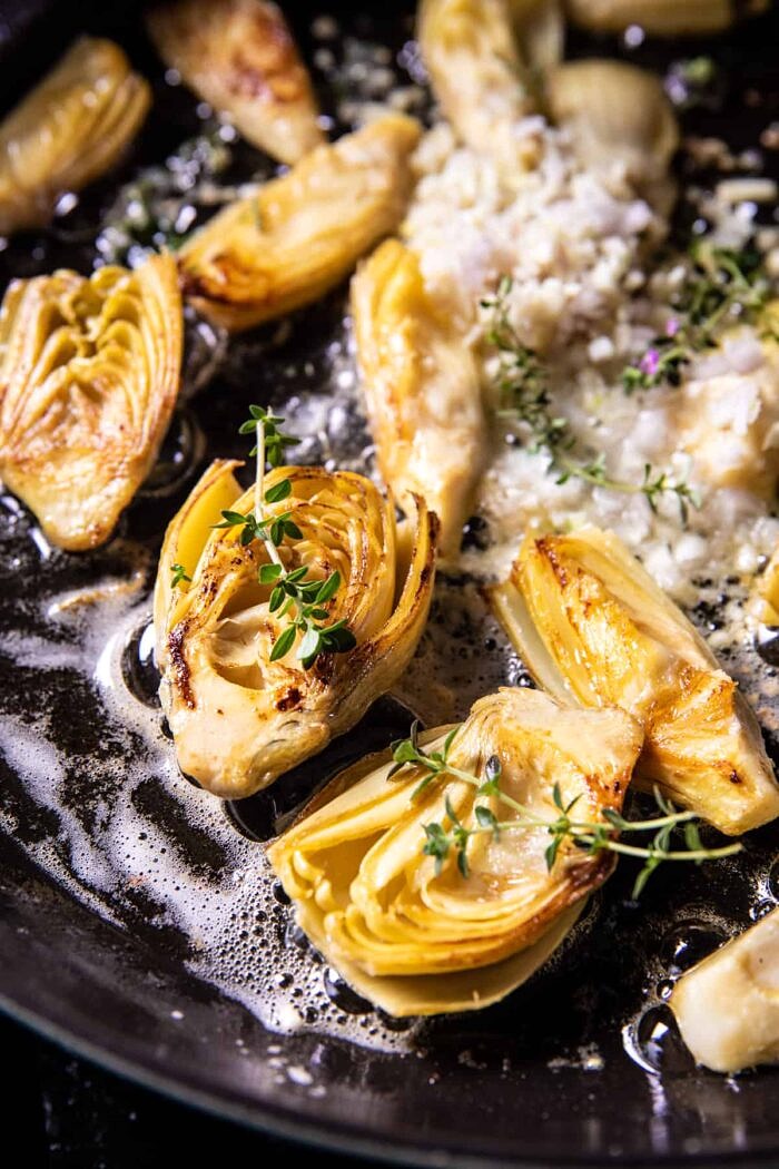 One Skillet Creamy Artichoke Chicken Marsala and Orzo | halfbakedharvest.com prep photo of artichokes cooking in skillet