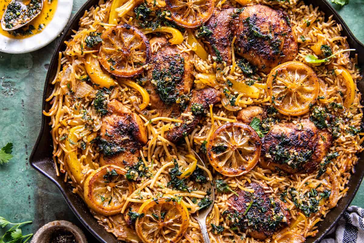 chicken and rice in skillet with herb butter and pepper on table