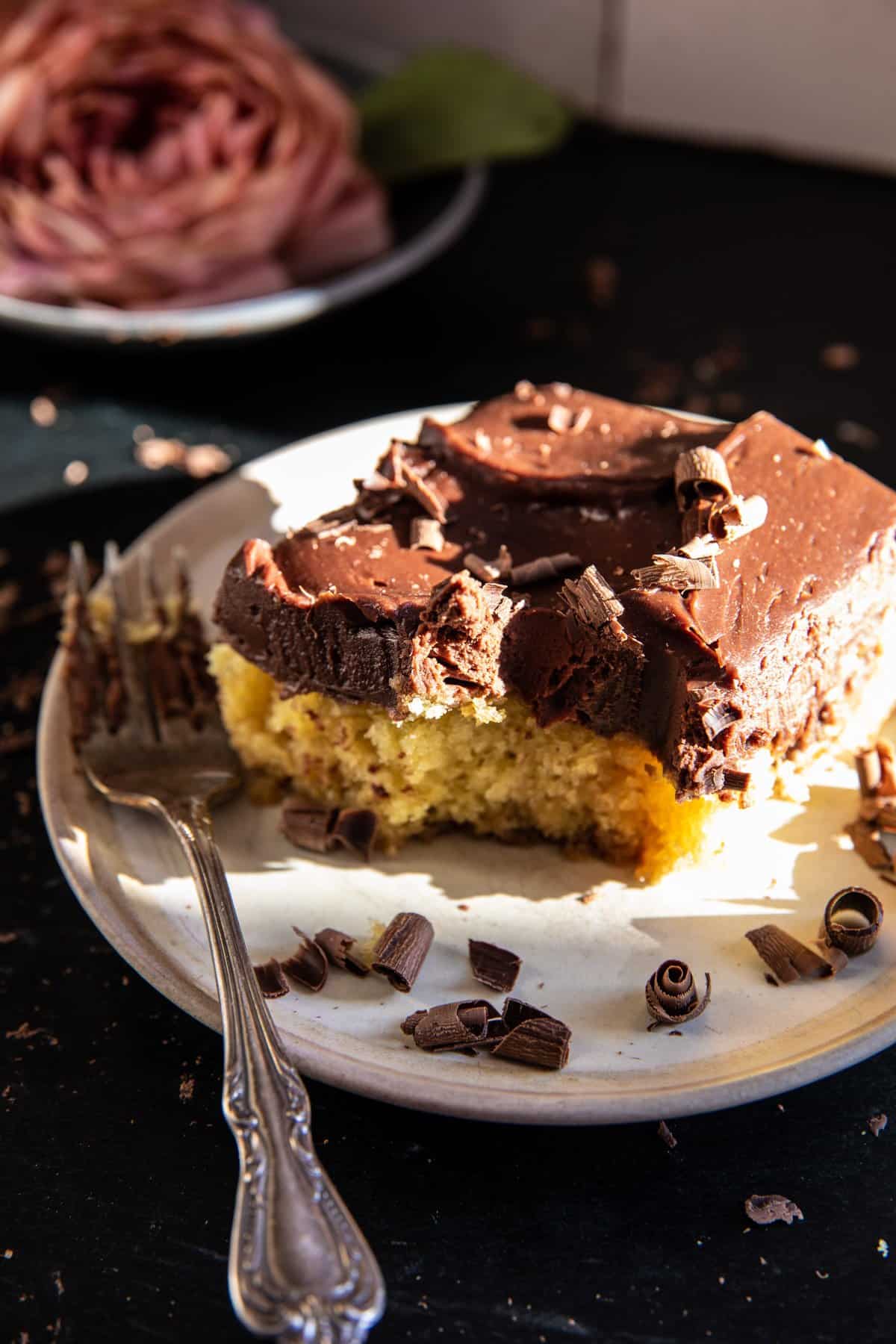 Swirled Caramel Sheet Cake with Fudgy Chocolate Frosting on a plate with a fork