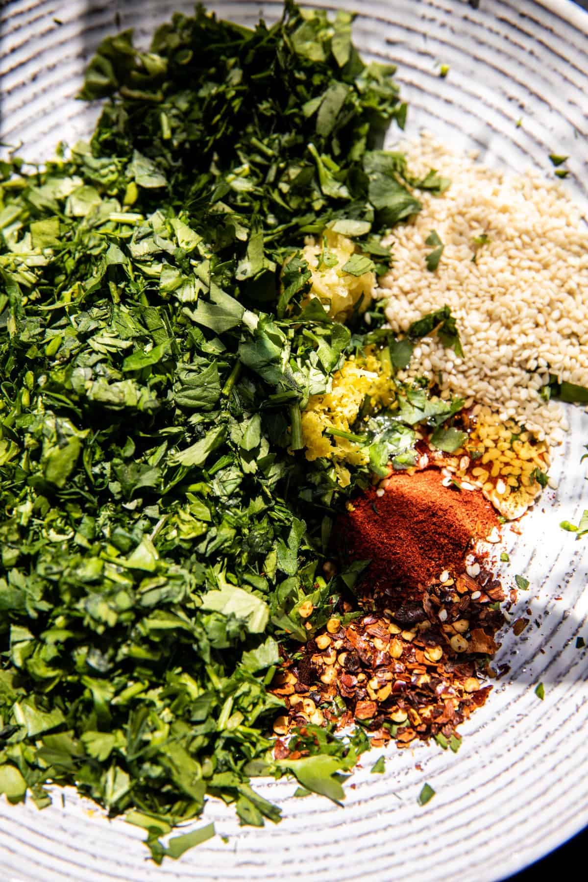 process photo of herbs in bowl for the chili oil 